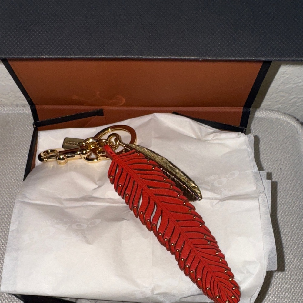 NWOT , Coach vintage red leather/ gold feather key/bag charm.